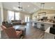 Spacious open-concept living room with vaulted ceilings, modern lighting, and access to the kitchen at 2144 Connie Ct, Franklin, IN 46131