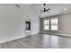 Large open room with neutral walls, laminate floors, and natural light from the windows at 2144 Connie Ct, Franklin, IN 46131