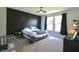 Modern bedroom with large windows, a dark accent wall, and a crib at 2144 Connie Ct, Franklin, IN 46131