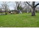 Sprawling green backyard featuring mature trees and a view of the house at 2302 W 61St St, Indianapolis, IN 46228