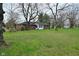 Large backyard featuring a brick home with a sunroom and lush lawn at 2302 W 61St St, Indianapolis, IN 46228