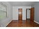 Bedroom with wood floors, natural light from the window, and a classic interior door at 2302 W 61St St, Indianapolis, IN 46228