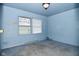 Simple blue bedroom with a window and plush carpeting at 2302 W 61St St, Indianapolis, IN 46228