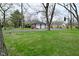 Long driveway leading to a brick house with an attached two-car garage at 2302 W 61St St, Indianapolis, IN 46228