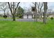 Brick home with attached two-car garage and basketball hoop in the driveway at 2302 W 61St St, Indianapolis, IN 46228