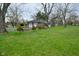 View of a brick house with a driveway and a two-car garage at 2302 W 61St St, Indianapolis, IN 46228