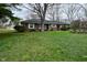 A ranch style home with a front lawn covered in purple wildflowers at 2302 W 61St St, Indianapolis, IN 46228