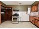 Eat-in kitchen featuring tile countertops, vintage cabinets and stainless steel oven at 2302 W 61St St, Indianapolis, IN 46228