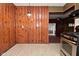 An eat-in kitchen featuring wood-paneled walls and a stainless steel oven at 2302 W 61St St, Indianapolis, IN 46228