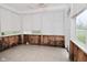 Sun room with peeling paint, damage, and large windows at 2302 W 61St St, Indianapolis, IN 46228