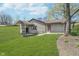 Expansive backyard showcasing lush green grass, hillside, and exterior of the home at 2305 Van Ness Pl, Indianapolis, IN 46240