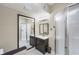 Cozy bathroom featuring a single sink vanity with a framed mirror and a shower at 2305 Van Ness Pl, Indianapolis, IN 46240
