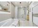 Bright bathroom with a soaking tub, tiled walls, and a separate glass shower at 2305 Van Ness Pl, Indianapolis, IN 46240
