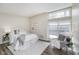 Bright bedroom with large window, comfortable bed, and a cozy chair at 2305 Van Ness Pl, Indianapolis, IN 46240
