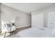 Neutral bedroom featuring a large bed, gray walls, and a chair in the corner at 2305 Van Ness Pl, Indianapolis, IN 46240