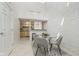Bright dining area with a modern table and chairs, alongside a beautiful brick wall at 2305 Van Ness Pl, Indianapolis, IN 46240