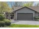 Charming home featuring a two-car garage, manicured lawn, and welcoming entryway at 2305 Van Ness Pl, Indianapolis, IN 46240