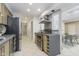 Modern kitchen showcasing stainless steel appliances, cooktop, and oven with views into the dining area at 2305 Van Ness Pl, Indianapolis, IN 46240