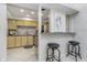 Inviting kitchenette featuring modern wood cabinets, stainless steel appliances and a bar counter with seating at 2305 Van Ness Pl, Indianapolis, IN 46240