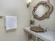 Stylish powder room featuring a unique sink, decorative mirror, and modern fixtures at 2305 Van Ness Pl, Indianapolis, IN 46240