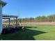 Picturesque backyard with a pergola, view of a pond, and a well-maintained lawn, creating a peaceful oasis at 2755 Ruffian Dr, Westfield, IN 46074