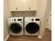 Well-equipped laundry room with modern washer and dryer, upper cabinets for storage, and durable flooring at 2755 Ruffian Dr, Westfield, IN 46074
