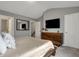 Bedroom with gray walls, stylish wooden dresser, and mounted television for modern living at 3123 Bolton Square Blvd, Indianapolis, IN 46222