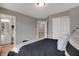 Neutral bedroom featuring a bed, view into the bathroom, and a closet for ample storage at 3123 Bolton Square Blvd, Indianapolis, IN 46222