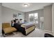 Cozy bedroom features a bed with black bedding and a comfortable chair near a bright window at 3123 Bolton Square Blvd, Indianapolis, IN 46222