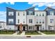 Modern townhome exterior with blue and grey siding and well-maintained landscaping with a black fence at 3123 Bolton Square Blvd, Indianapolis, IN 46222