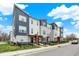 Modern townhome with landscaped front yard and blue and gray exterior paint, showcasing a contemporary design at 3123 Bolton Square Blvd, Indianapolis, IN 46222