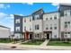 Modern townhome exterior with blue and grey siding and well-maintained landscaping with a black fence at 3123 Bolton Square Blvd, Indianapolis, IN 46222