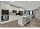 Modern kitchen with white cabinetry, stainless steel appliances, and a breakfast bar, offering both style and functionality at 3123 Bolton Square Blvd, Indianapolis, IN 46222