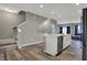 Kitchen island with white cabinets and stainless steel dishwasher overlooking the living area with stairs nearby at 3123 Bolton Square Blvd, Indianapolis, IN 46222