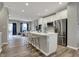Bright open kitchen featuring an island with seating and stainless steel appliances overlooking the living area at 3123 Bolton Square Blvd, Indianapolis, IN 46222