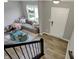 Bright and stylish living room featuring a grey sofa, staircase, and modern decor for a comfortable living space at 3123 Bolton Square Blvd, Indianapolis, IN 46222