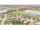 Aerial view of a neighborhood near a lake and golf course, featuring well-maintained lawns and mature trees at 3130 Shadow Lake Dr, Indianapolis, IN 46217