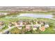 Aerial view of neighborhood homes near a pond and golf course, featuring manicured lawns and mature trees at 3130 Shadow Lake Dr, Indianapolis, IN 46217