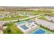 Aerial view of the community pool and tennis courts in a neighborhood with green lawns at 3130 Shadow Lake Dr, Indianapolis, IN 46217