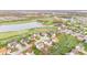 Aerial view of homes nestled along a golf course and pond, showing well-kept lawns and mature trees at 3130 Shadow Lake Dr, Indianapolis, IN 46217