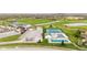This aerial shot features a clubhouse near tennis courts, a pool, and a parking area at 3130 Shadow Lake Dr, Indianapolis, IN 46217