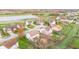 An aerial view of homes with backyards featuring playsets and well-maintained landscaping near a scenic pond at 3130 Shadow Lake Dr, Indianapolis, IN 46217