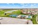 An aerial view captures the tennis courts, pool, lakes, and green spaces amidst a residential area at 3130 Shadow Lake Dr, Indianapolis, IN 46217