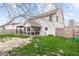 Spacious backyard featuring a screened-in porch, pergola, grassy area, and fenced perimeter at 3130 Shadow Lake Dr, Indianapolis, IN 46217
