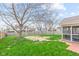 View of the spacious backyard with a screened porch and fenced perimeter at 3130 Shadow Lake Dr, Indianapolis, IN 46217