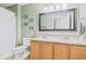 Bathroom features double sinks, a shower with curtain, and a decorative mirror with 'wash, brush, flush' signage at 3130 Shadow Lake Dr, Indianapolis, IN 46217