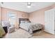 Cozy bedroom featuring a bed, chair, and soft carpet, illuminated by natural light, creating a serene space at 3130 Shadow Lake Dr, Indianapolis, IN 46217