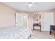 This bedroom features a bed with decorative pillows, a vintage table, and an array of framed artwork at 3130 Shadow Lake Dr, Indianapolis, IN 46217