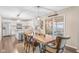 Dining room featuring hardwood floors, a wooden table, and seating for six, with a kitchen in the background at 3130 Shadow Lake Dr, Indianapolis, IN 46217