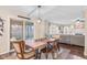 Open dining room with wood table and chairs, leading to outdoor patio and living room at 3130 Shadow Lake Dr, Indianapolis, IN 46217